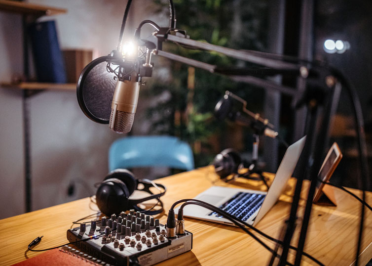 Appraisal podcast studio setup with microphone, laptop, and audio equipment