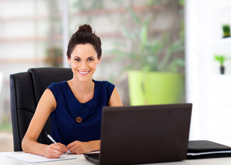 Smiling appraiser sitting at a clean, organized desk