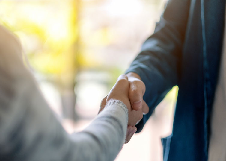 Real estate appraiser shaking hands with an appraisal client