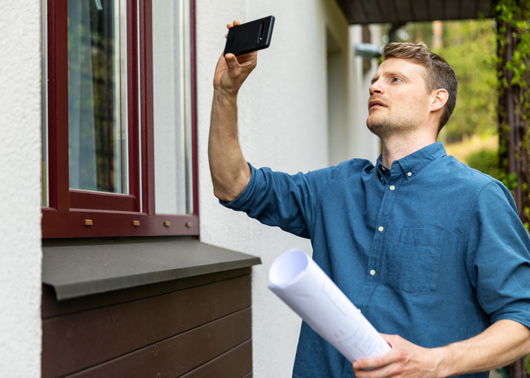 Real estate appraiser completing taking photos on phone