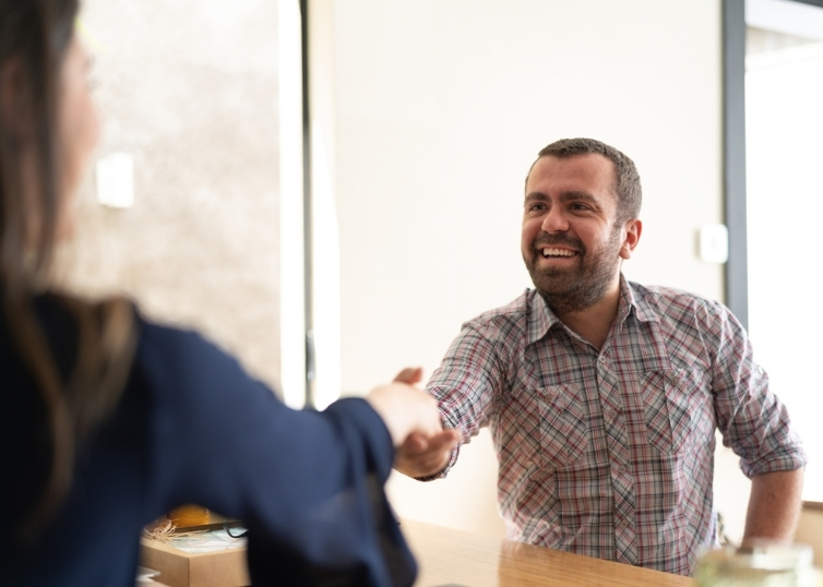Woman shaking hands with trainee appraiser at job interview
