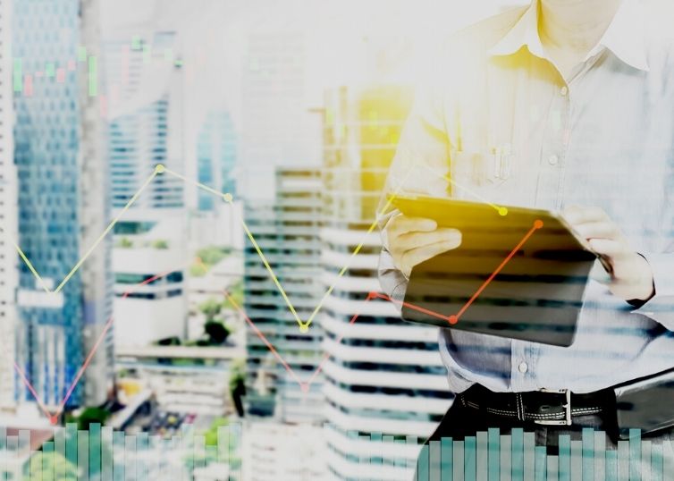 Businessman holding tablet, analyzing 2020 housing market data